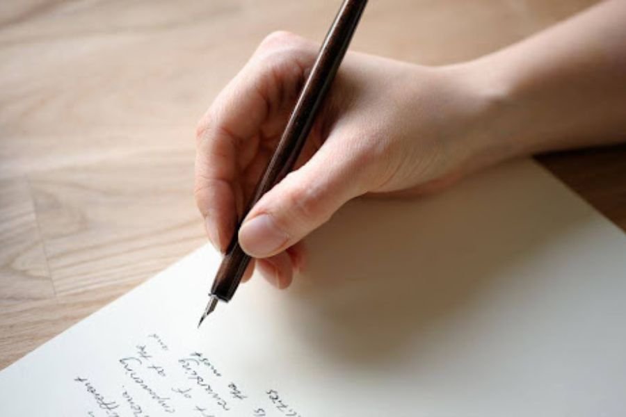 A person having using a pen in his hand for will writing
